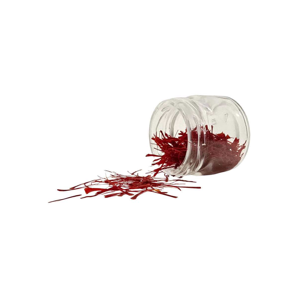 Super Negin saffron threads spilling from a glass jar